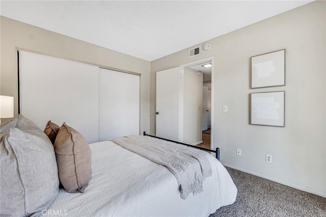 bedroom with a closet and carpet flooring