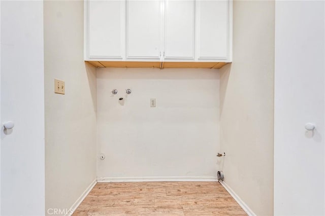 clothes washing area featuring light wood-type flooring, cabinets, hookup for a washing machine, and hookup for a gas dryer