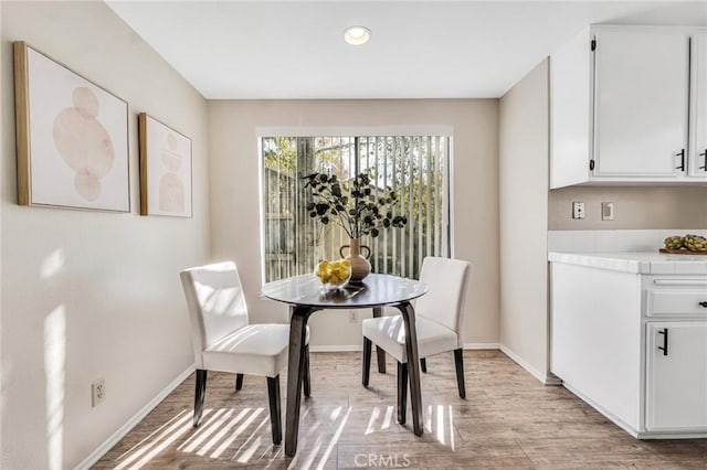 dining space featuring light wood-type flooring