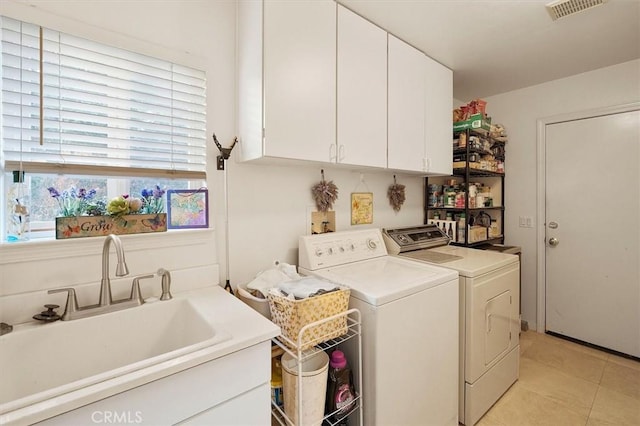 washroom with washer and dryer, cabinets, sink, and light tile patterned flooring