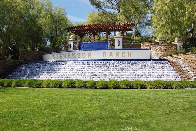 community / neighborhood sign with a lawn