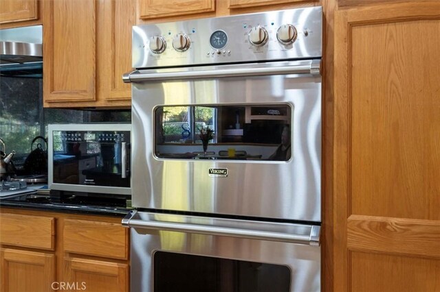 kitchen featuring decorative backsplash and stainless steel double oven