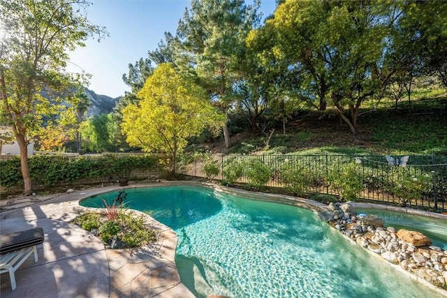 view of pool with a patio area and a mountain view