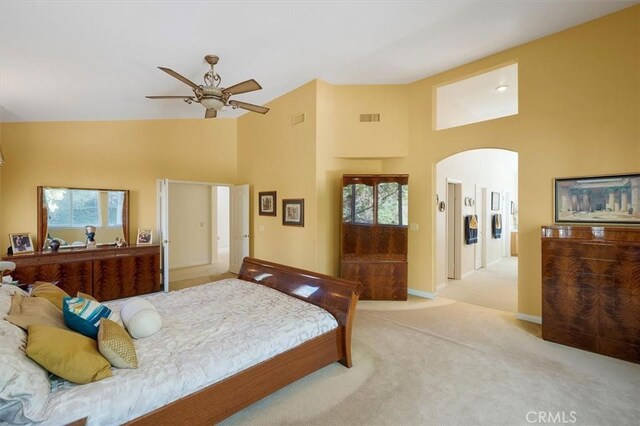 bedroom featuring ceiling fan, light colored carpet, and high vaulted ceiling