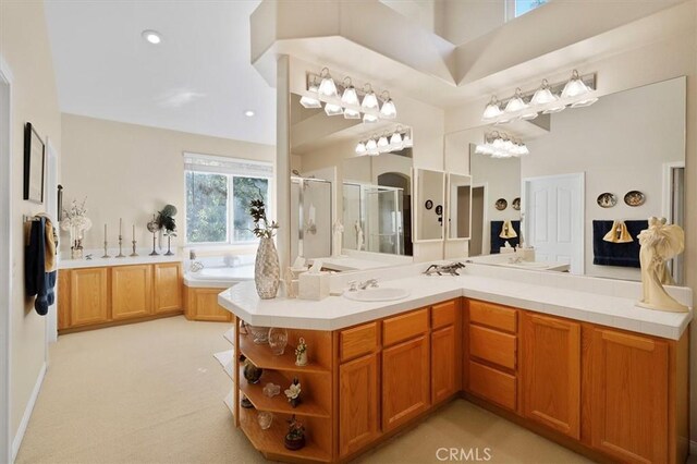 bathroom with vanity and shower with separate bathtub