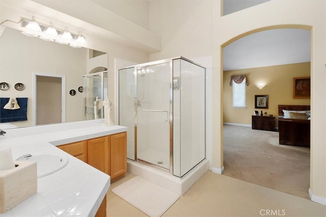 bathroom with a shower with shower door and vanity