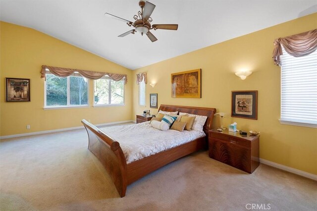 bedroom featuring ceiling fan, light colored carpet, and vaulted ceiling