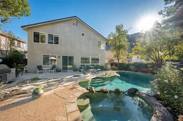 view of pool featuring an outdoor kitchen, a grill, a patio, and an in ground hot tub