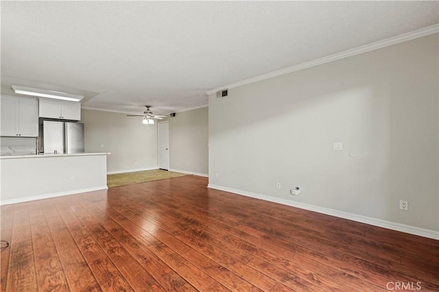 unfurnished living room with crown molding, ceiling fan, and hardwood / wood-style flooring