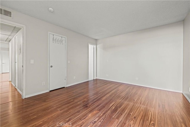 spare room with hardwood / wood-style floors