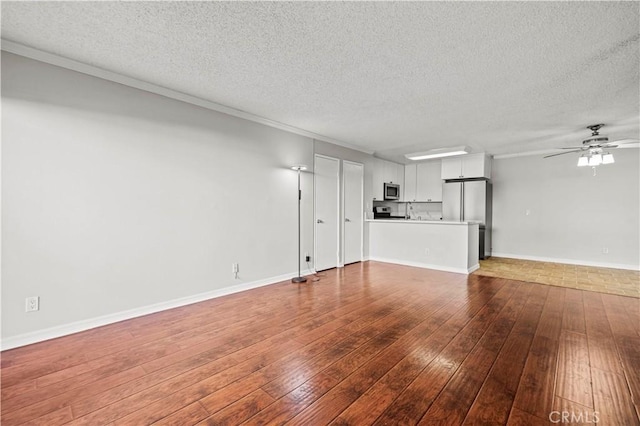 unfurnished living room with ceiling fan, wood-type flooring, and a textured ceiling