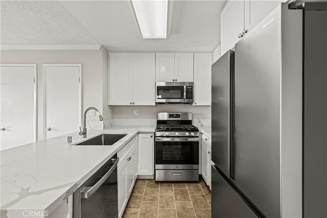 kitchen featuring appliances with stainless steel finishes, sink, and white cabinets