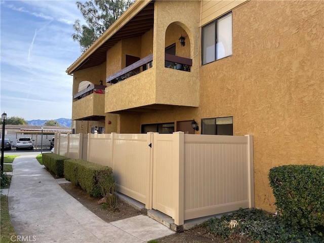 view of home's exterior with a mountain view and a balcony