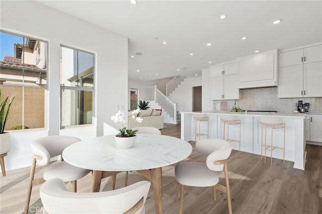 dining area featuring a wealth of natural light and hardwood / wood-style flooring