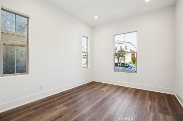 empty room with dark wood-type flooring