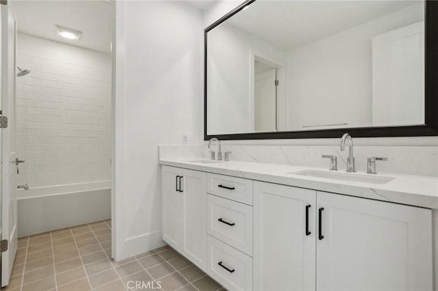 bathroom featuring vanity, tile patterned flooring, and tiled shower / bath