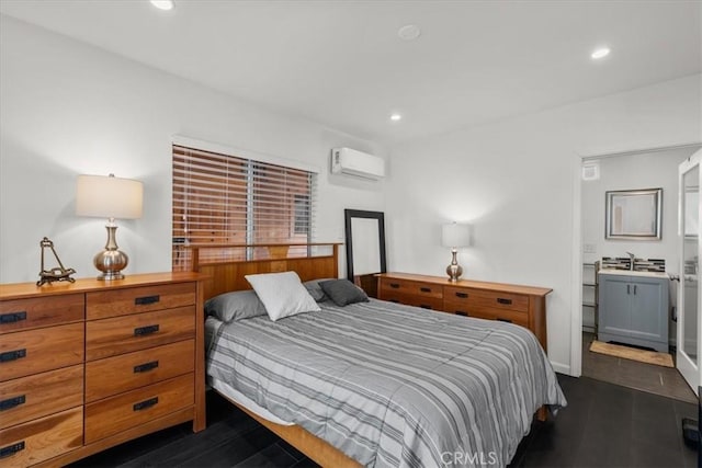 bedroom with dark hardwood / wood-style floors and a wall unit AC