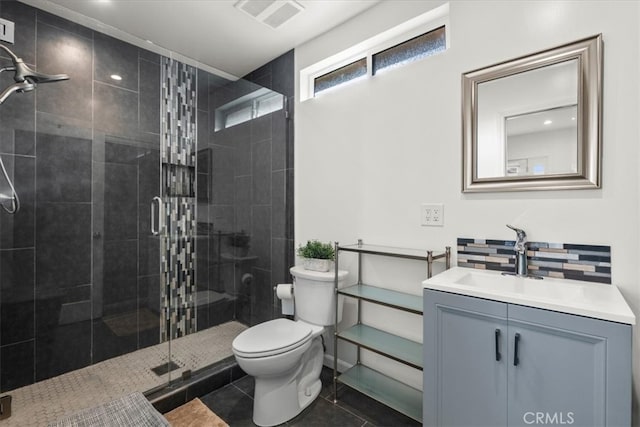 bathroom featuring toilet, walk in shower, vanity, and tile patterned flooring