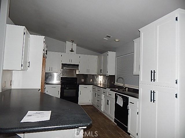 kitchen featuring white cabinets, dishwasher, tasteful backsplash, sink, and stove