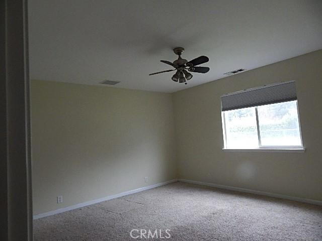 carpeted empty room featuring ceiling fan