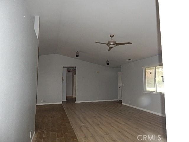 unfurnished living room featuring ceiling fan, dark hardwood / wood-style flooring, and lofted ceiling