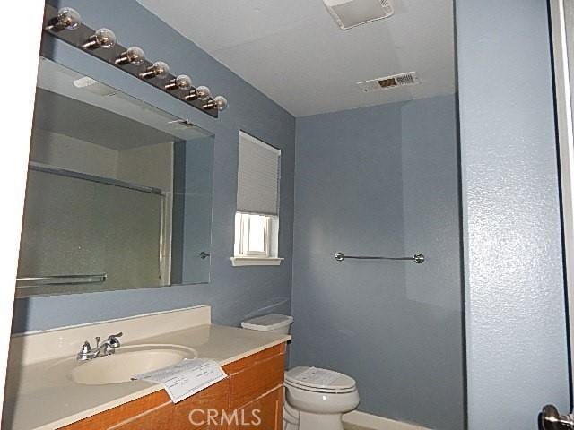 bathroom with toilet and vanity