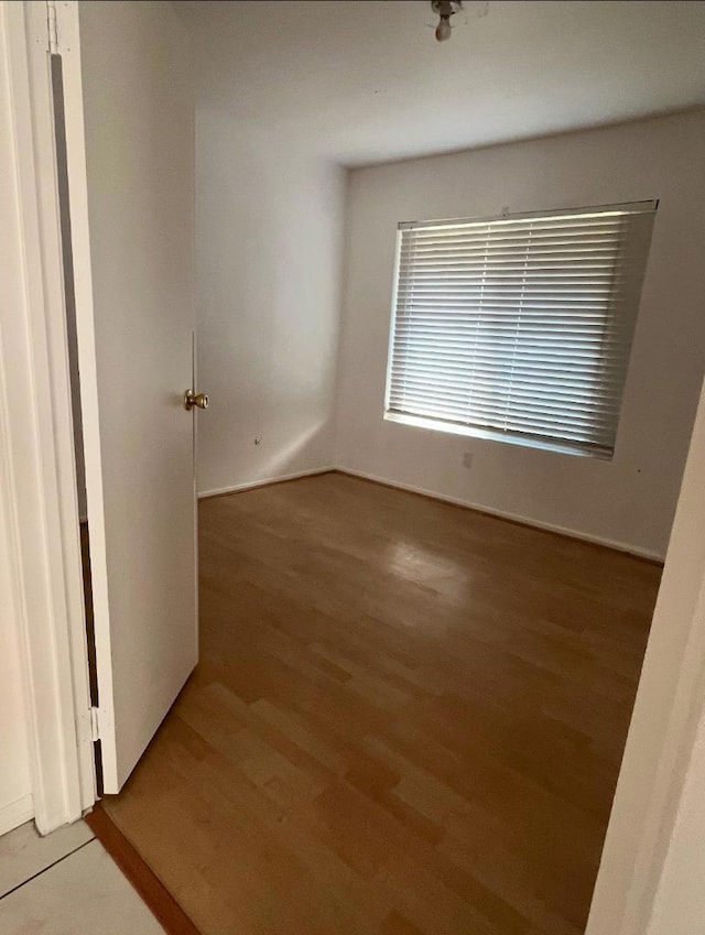 empty room with wood-type flooring