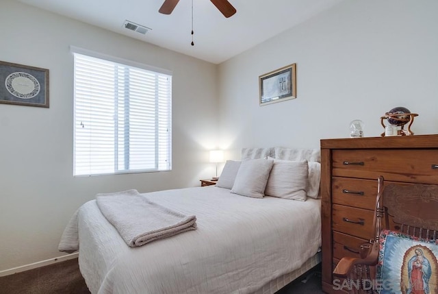 bedroom featuring ceiling fan and dark carpet