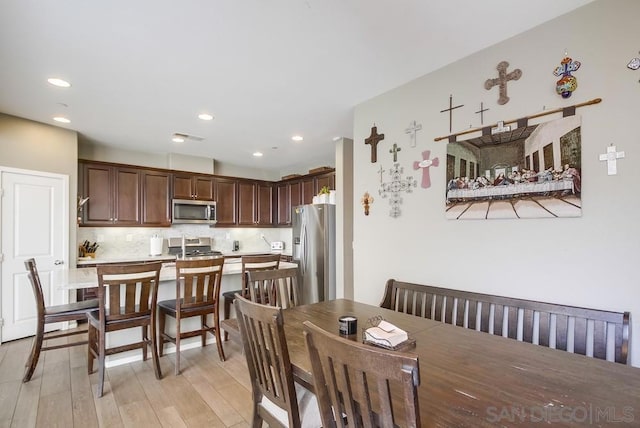 dining space with light hardwood / wood-style flooring