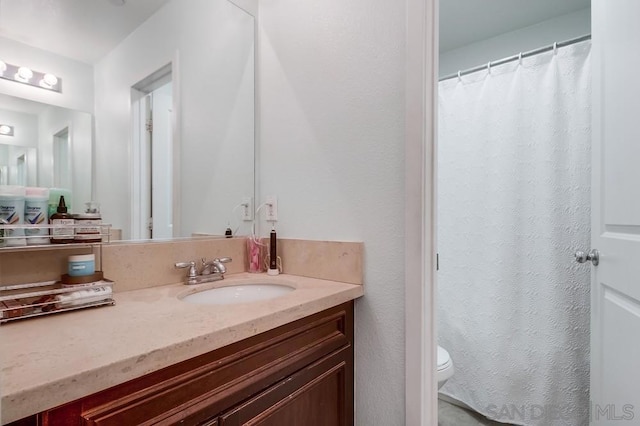 bathroom with toilet and vanity