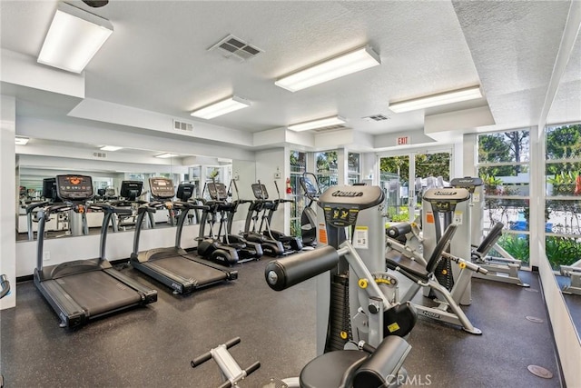 gym with a textured ceiling