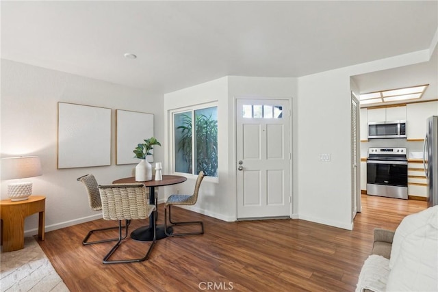 dining space with wood-type flooring