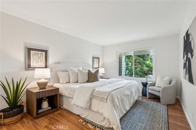 bedroom with hardwood / wood-style floors