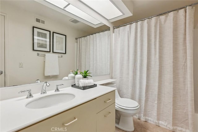 bathroom with curtained shower, tile patterned floors, vanity, and toilet