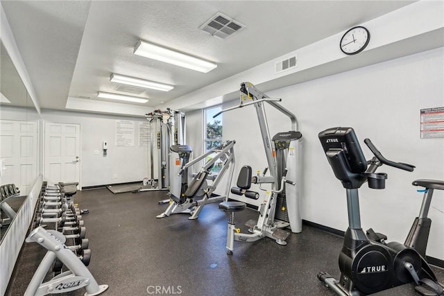 workout area featuring a textured ceiling