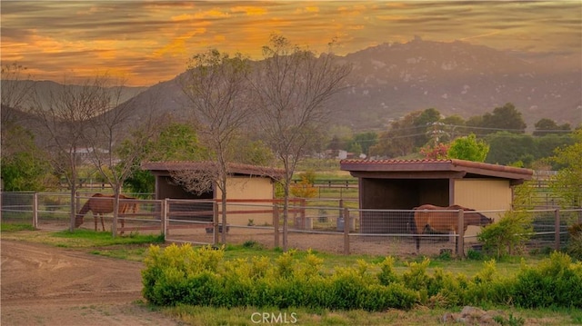 view of horse barn with a mountain view