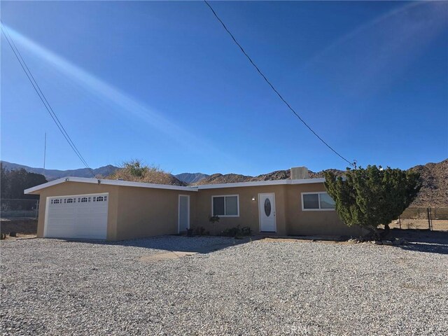 view of front of home featuring a garage and a mountain view