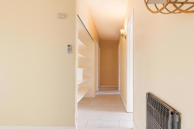 hall featuring light tile patterned floors