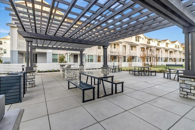 view of property's community featuring a pergola and a patio area