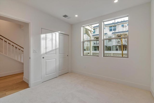 unfurnished room with light colored carpet