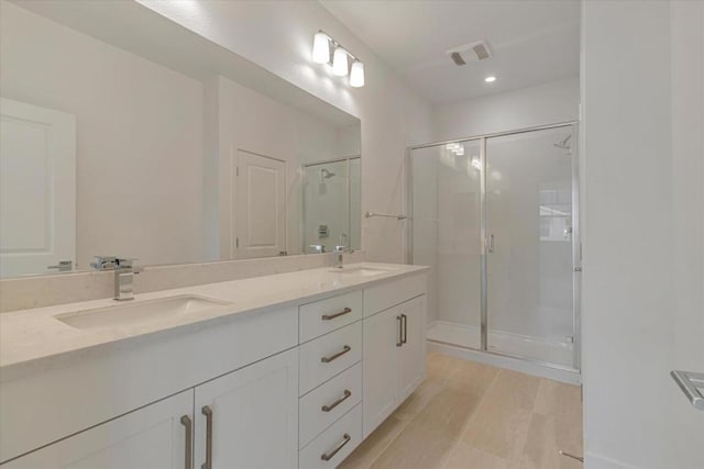 bathroom with an enclosed shower and vanity