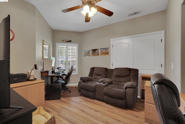 living room with ceiling fan and light hardwood / wood-style flooring