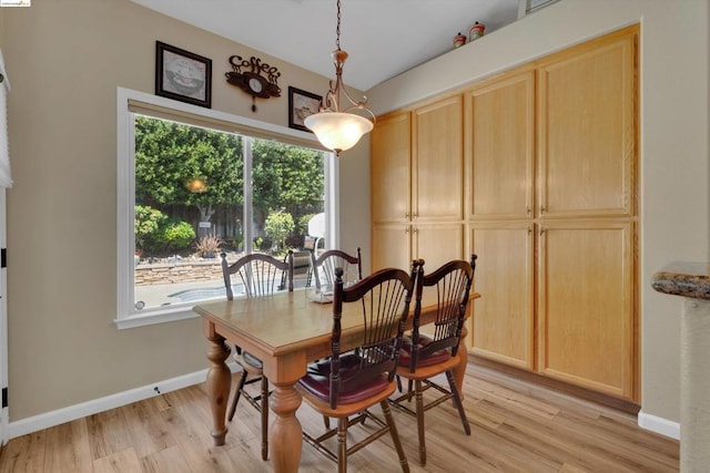 dining space with light hardwood / wood-style floors