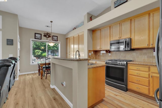 kitchen with a center island with sink, stainless steel appliances, decorative backsplash, light stone countertops, and pendant lighting