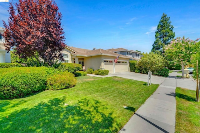 view of front of property featuring a garage and a front lawn