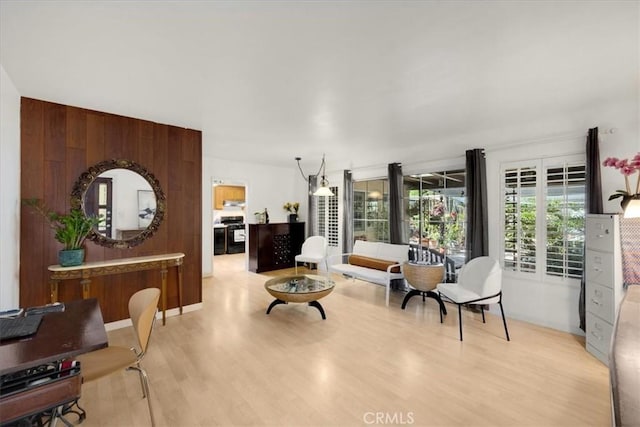 sitting room featuring french doors and light hardwood / wood-style flooring