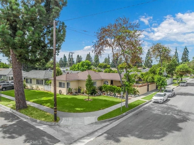 single story home featuring a front lawn