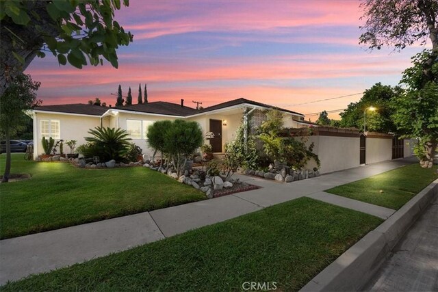 ranch-style house featuring a lawn