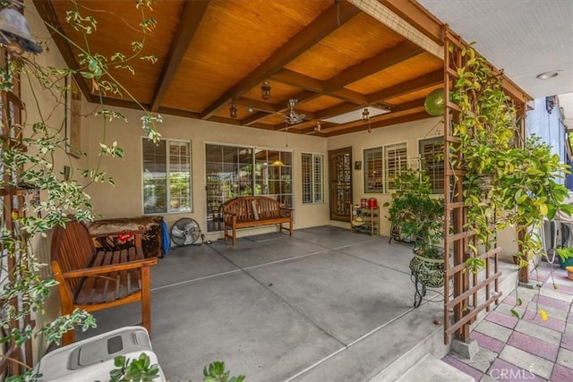 sunroom / solarium featuring beamed ceiling