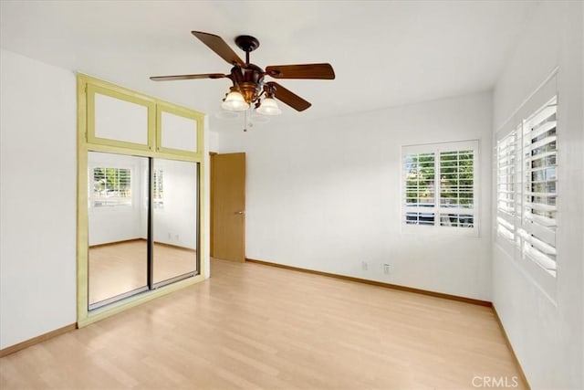 spare room featuring light hardwood / wood-style flooring and ceiling fan